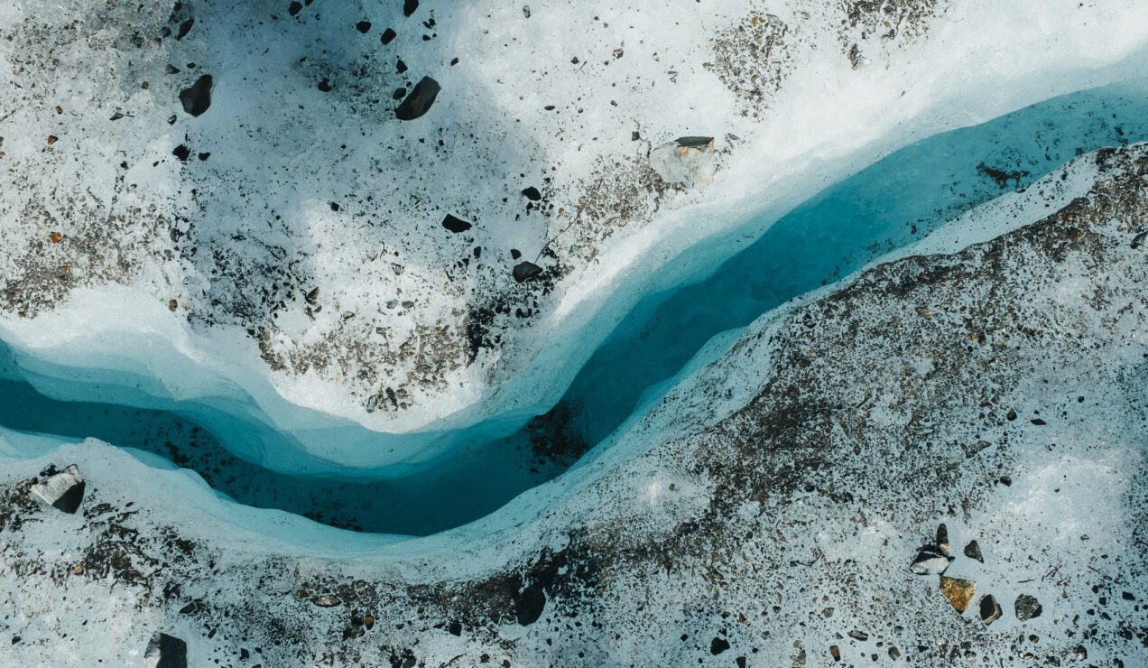 A crack in ice of a glacier carved out by running water