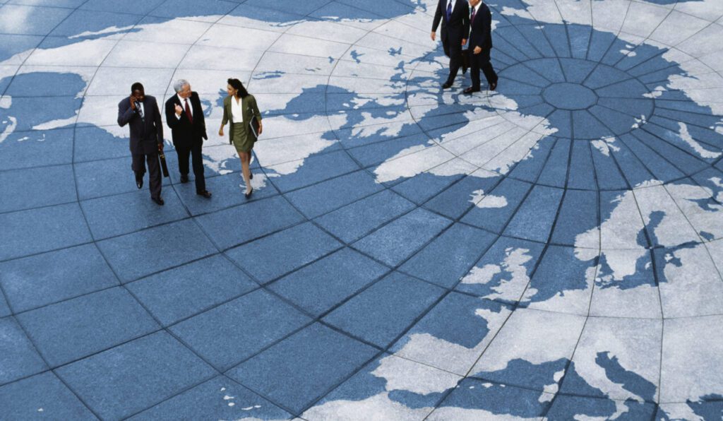 Businesspeople walking on map of globe